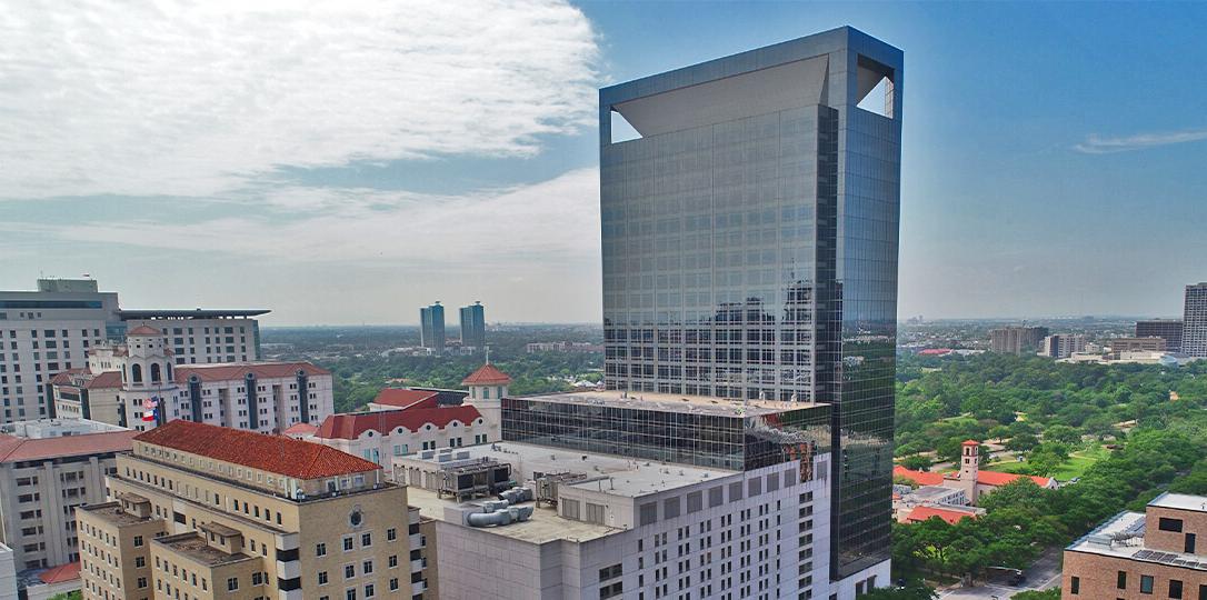 A skyscraper and a park in the background